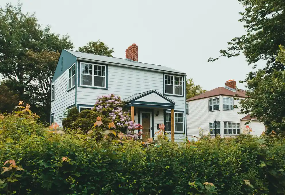 Blue two-story house in a suburban neighborhood