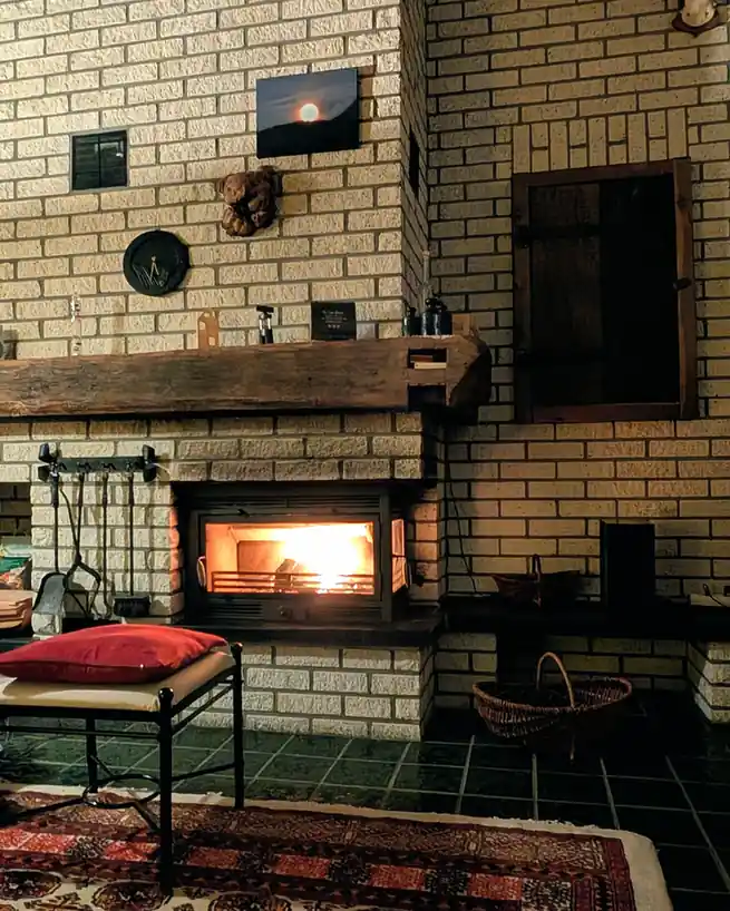 Warm living room with a lit fireplace