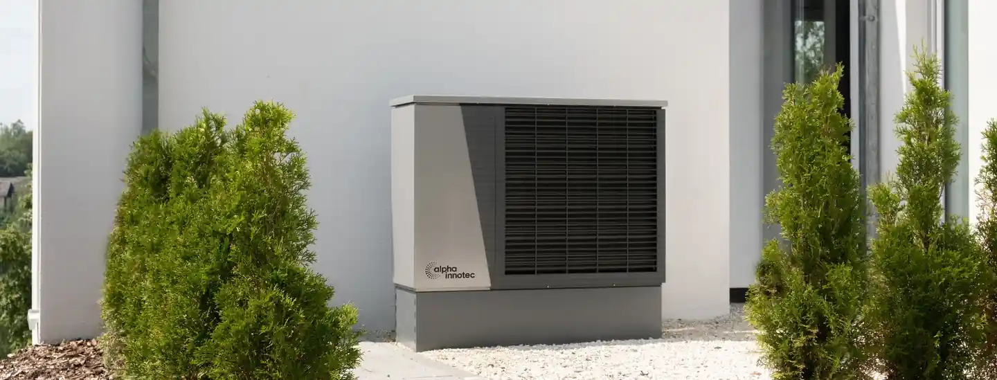 Outdoor air conditioning unit beside a modern home