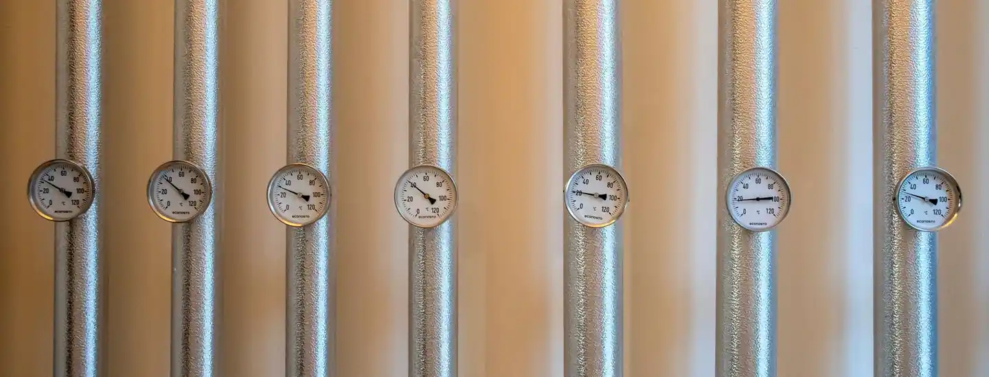 Row of pressure gauges on silver heating pipes