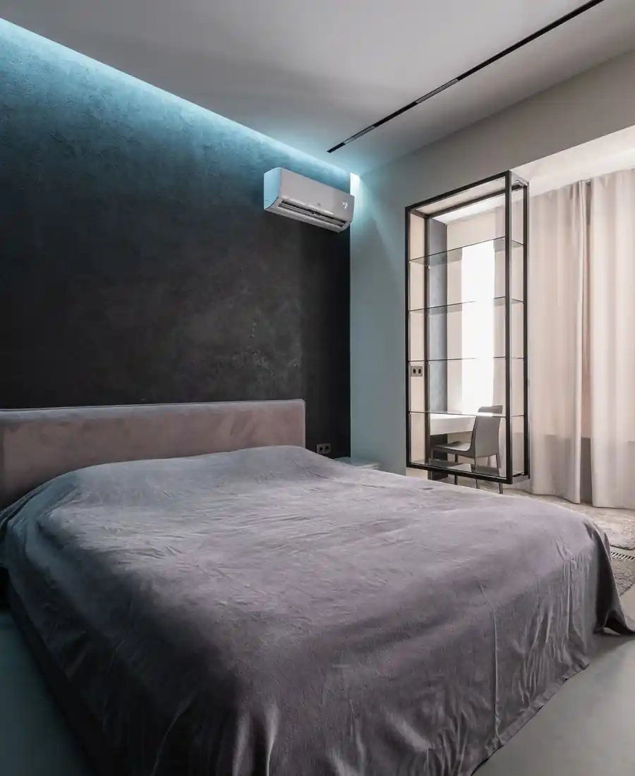 Bedroom with a wall-mounted air conditioner