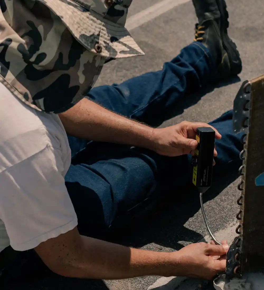 Technician repairing an air conditioning unit outdoors
