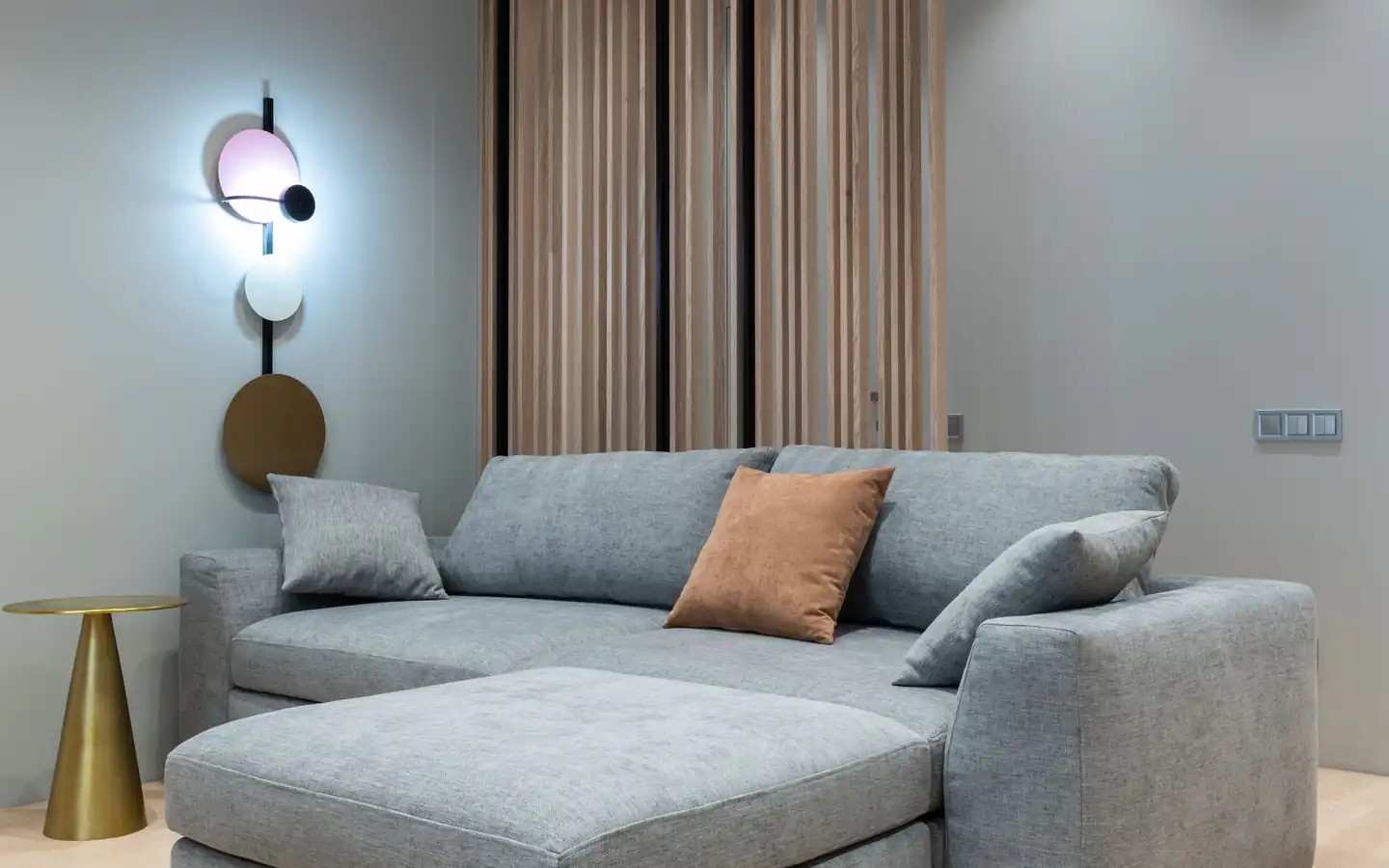 Living room with a sofa and a wall-mounted air conditioner